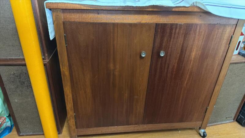 Wooden storage cabinet on casters